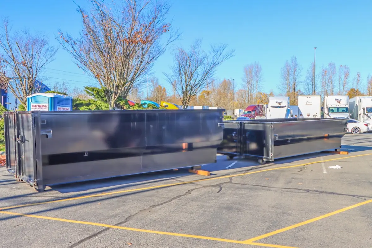 Professional dumpster rental service with roll-off container on residential driveway in Statesville